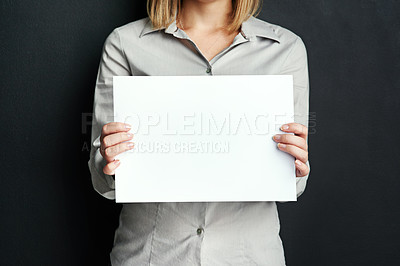 Buy stock photo Mockup, hand and woman with poster for advertising board, design or marketing info in studio. Female person, blank paper and banner with space for promotion, branding and news on black background