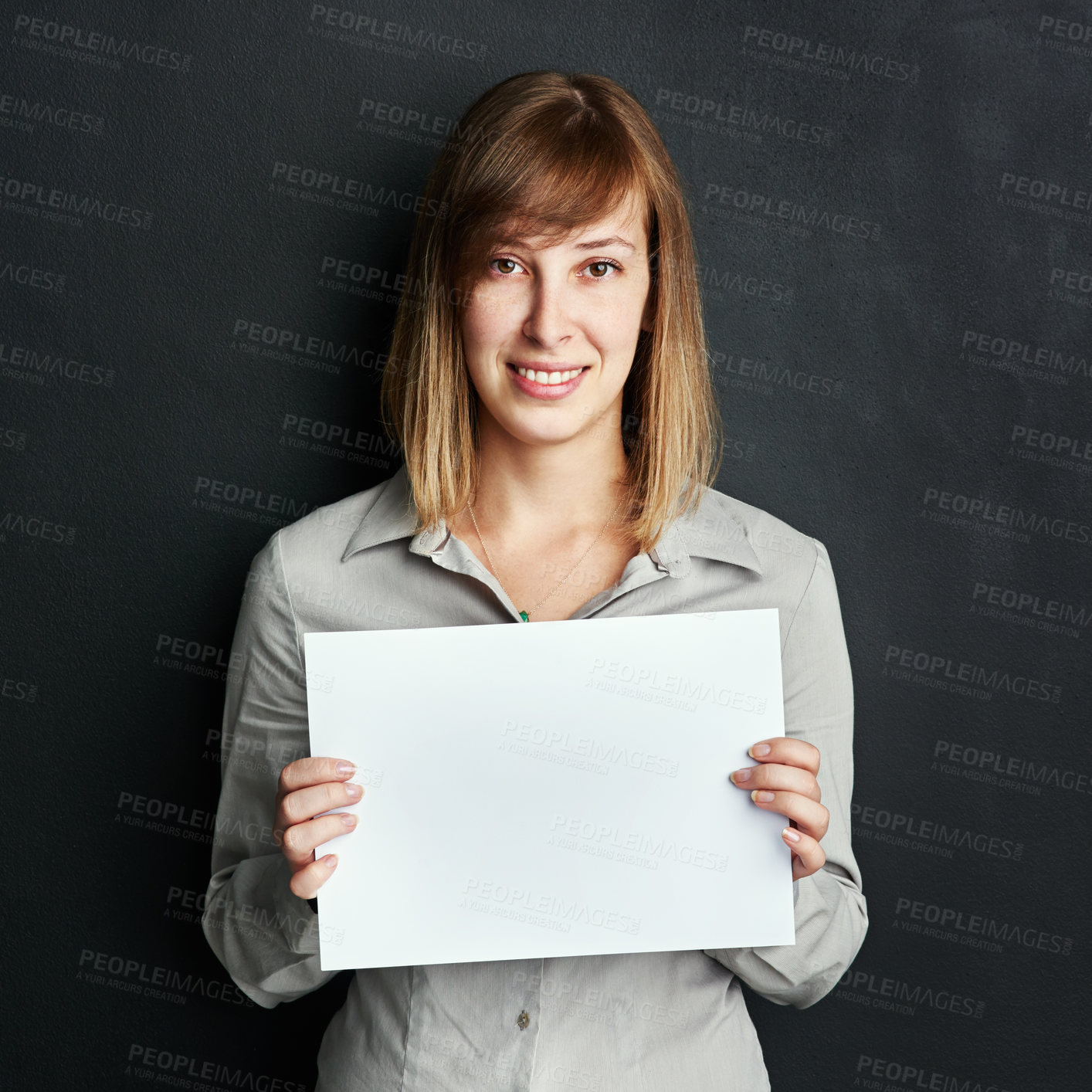 Buy stock photo Portrait, poster and mock up with a woman in studio on a dark background holding a blank sign. Announcement, information or advertising with a female brand ambassador showing empty space on a placard