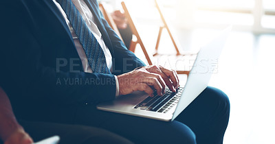 Buy stock photo Cropped shot of an unrecognizable businessman taking notes on his laptop during a meeting