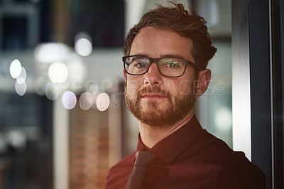 Buy stock photo Portrait of a confident young businessman standing in a modern office