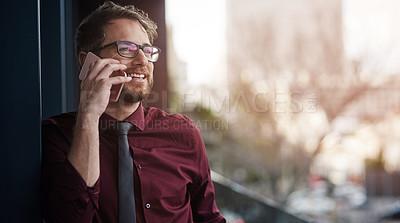 Buy stock photo Shot of a young businessman using a mobile phone on the balcony of an office