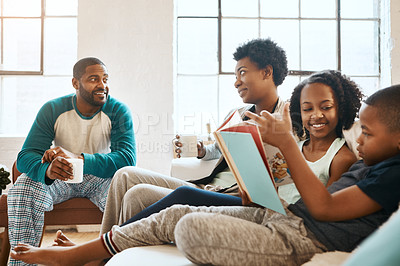 Buy stock photo Black family, reading book and kids on couch in home, care and learning for language with coffee. African parents, children and storytelling for connection, bonding and relax in pajamas in morning