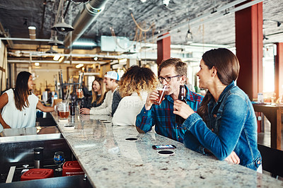 Buy stock photo Shot of a couple enjoying a drink at a bar