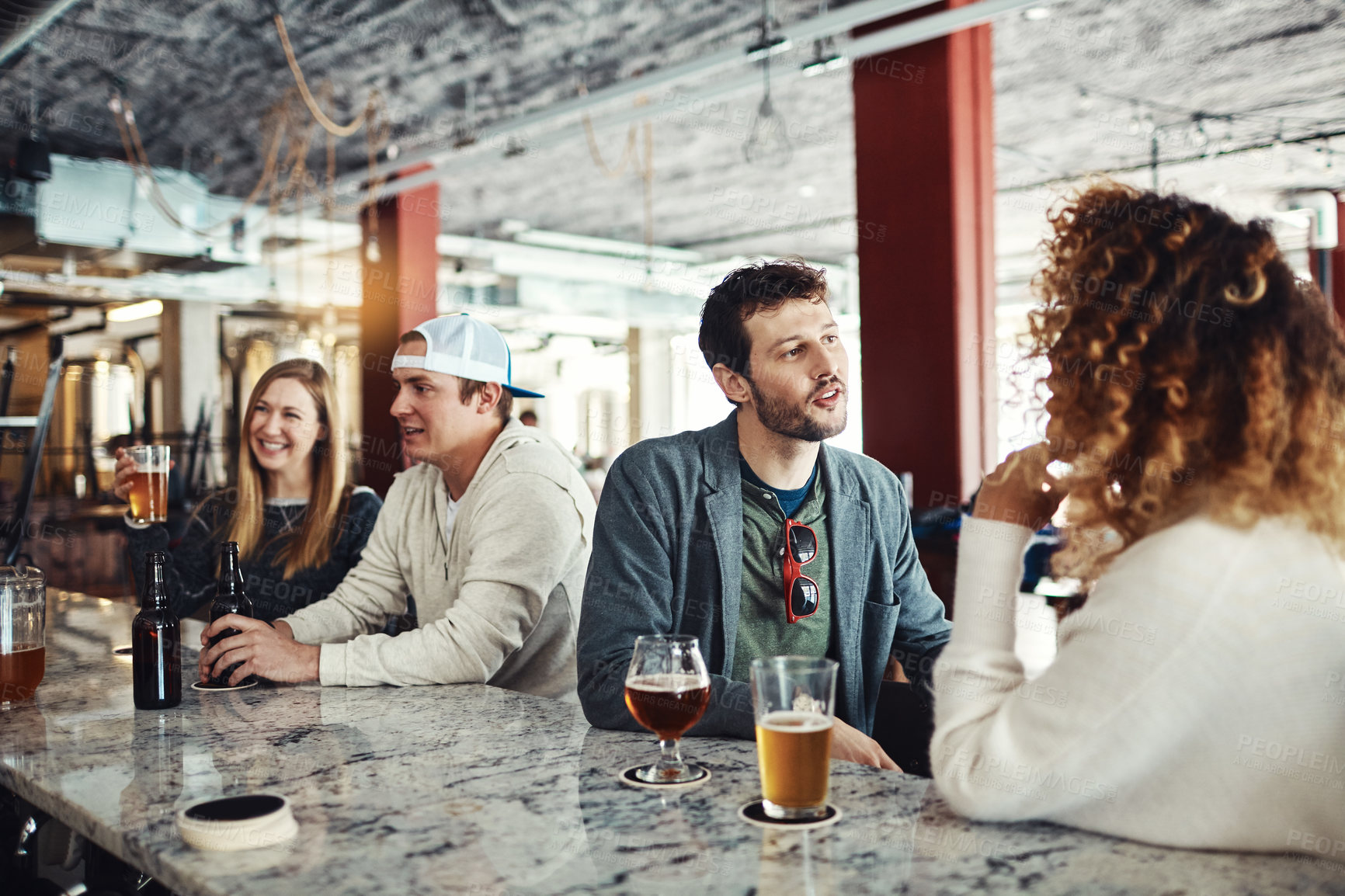 Buy stock photo Shot of a couple enjoying a drink at a bar