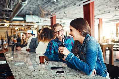 Buy stock photo Shot of a couple enjoying a drink at a bar