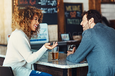 Buy stock photo Shot of a couple enjoying a drink at a bar