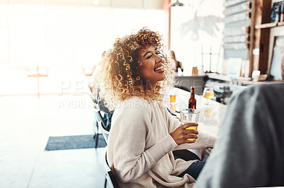Buy stock photo Shot of a young woman enjoying a drink at a bar 