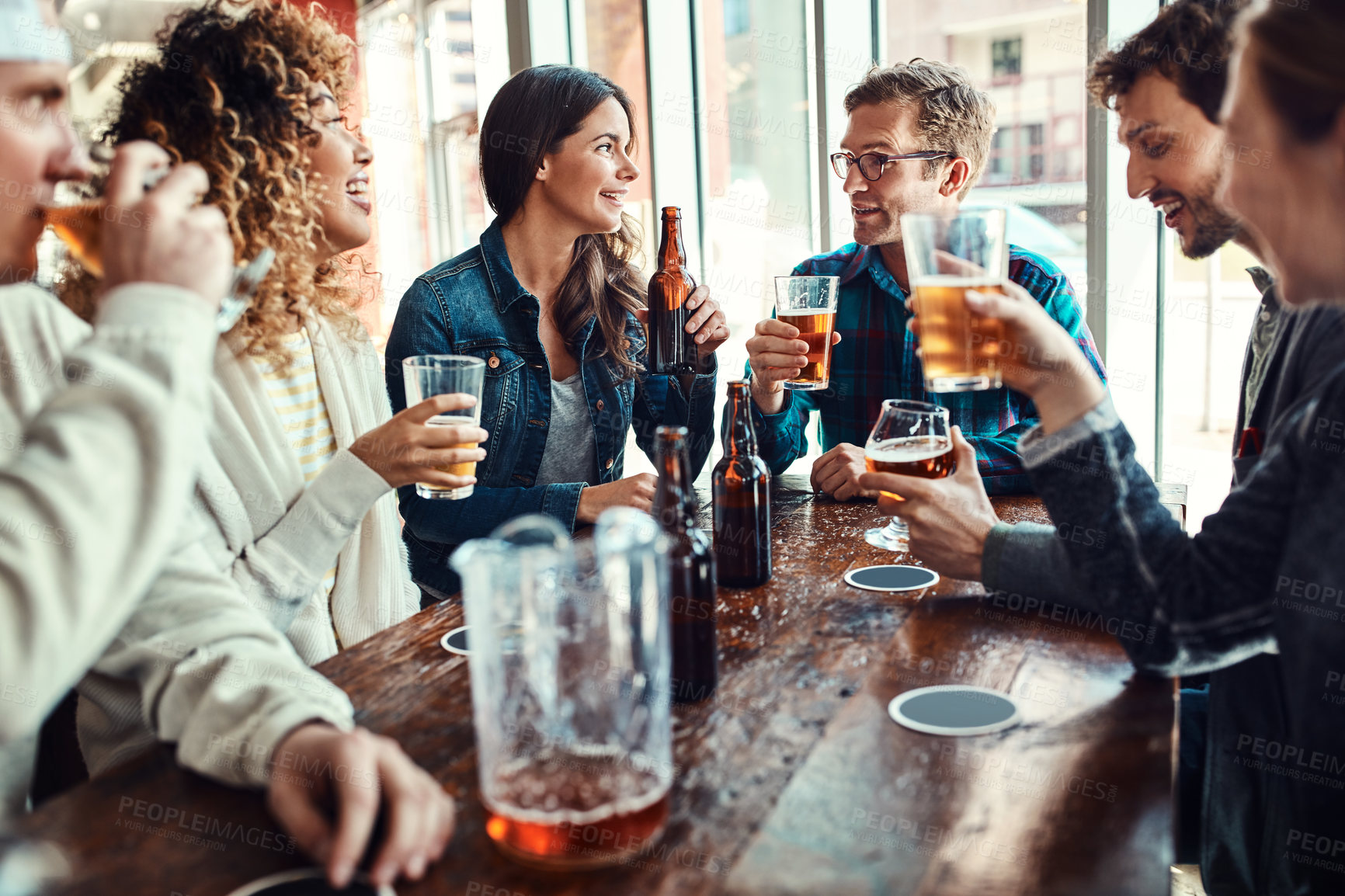 Buy stock photo Restaurant, beer and friends at gen z hangout in celebration of birthday event in urban New York bar. Group of people with smile for happiness and gathering together with alcohol beverage at lunch