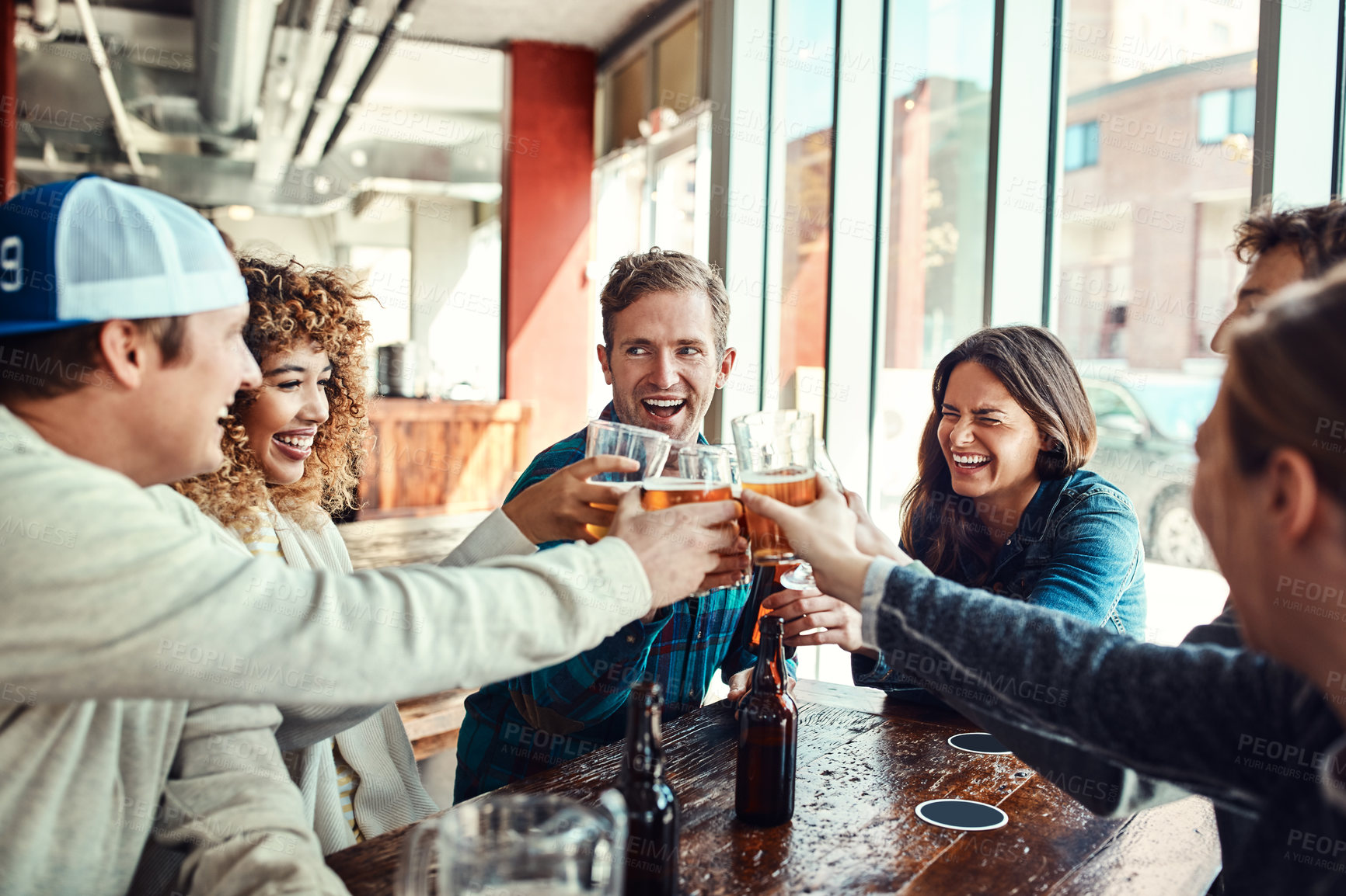 Buy stock photo Friends, people and happy with beer in pub for cheers on date for reunion, gathering and fun. Glass, laughing and smile for celebrating with bonding, drinking alcohol and together in bar for support