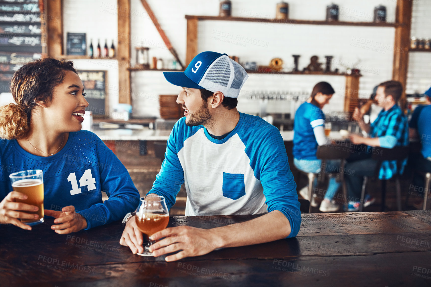 Buy stock photo Sports, chat or couple in pub with beer, popcorn or social celebration of competition together. Relax, soccer game or people in bar for watch party, alcohol drinks or fans at diner for happy hour