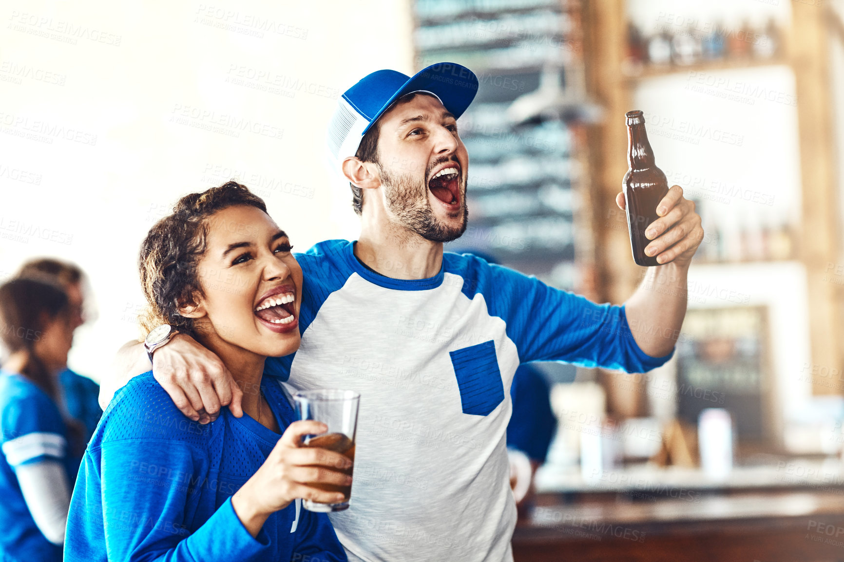 Buy stock photo Sports, goal or couple in pub with alcohol, smile or celebration of competition, winning or score. Excited, soccer game or people in bar for watch party, beer drinks or fans at diner for happy hour