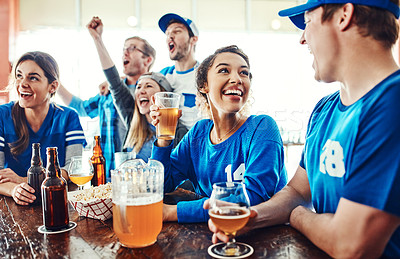 Buy stock photo Shot of a young woman and man having a conversation while drinking beer in a sports bar