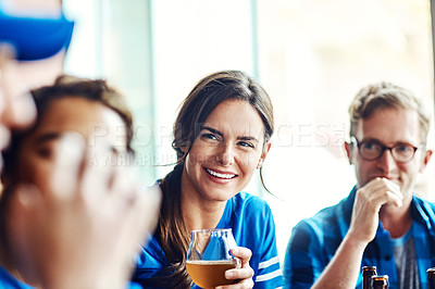 Buy stock photo Shot of a group of friends enjoying themselves in a bar