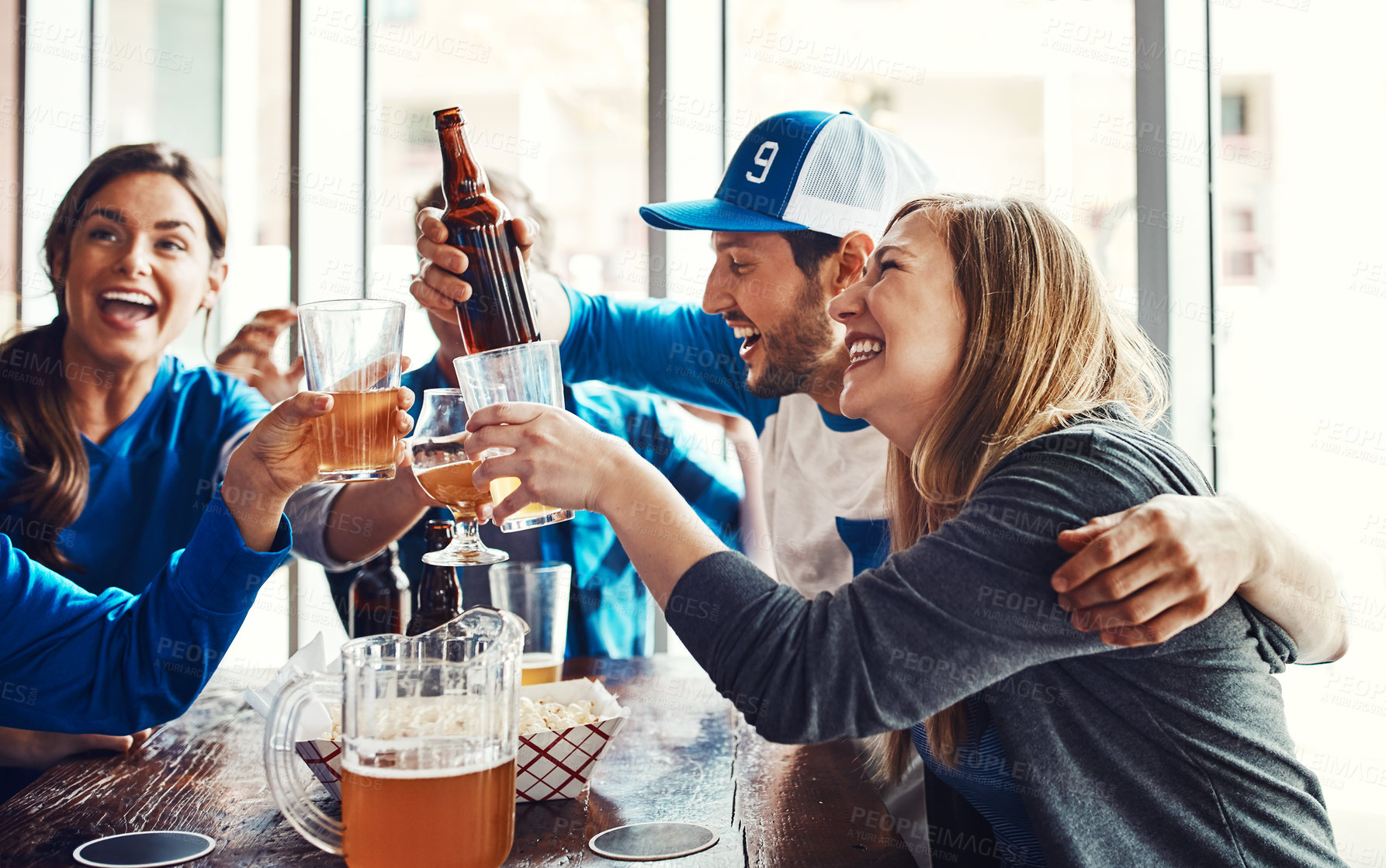 Buy stock photo Sports, fans and toast with drinks for celebration, support and people watching tv team game in restaurant. Friends, cheers and live streaming with happiness, excited and pride for baseball win