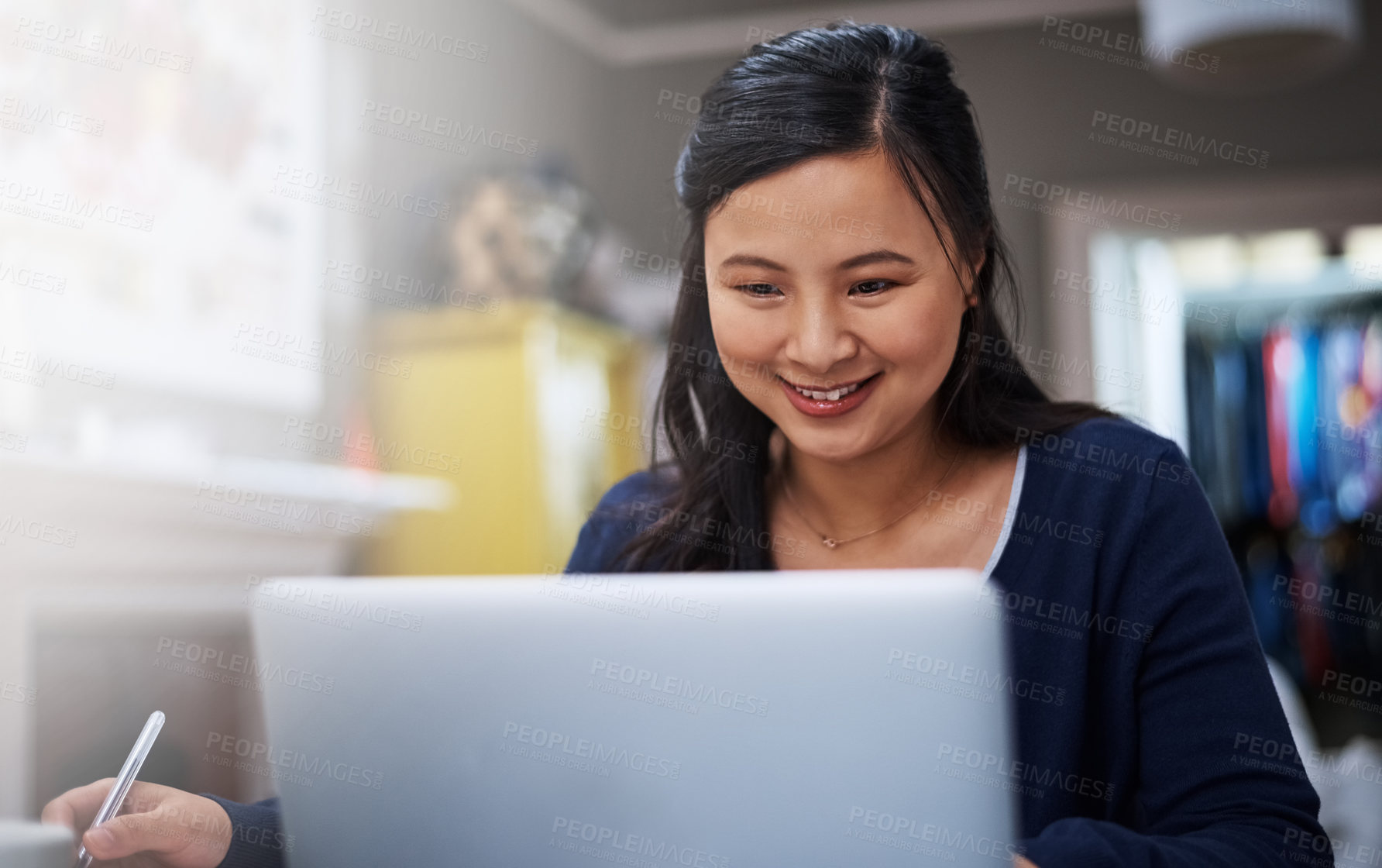 Buy stock photo Cropped shot of an attractive young female entrepreneur working on her laptop at home