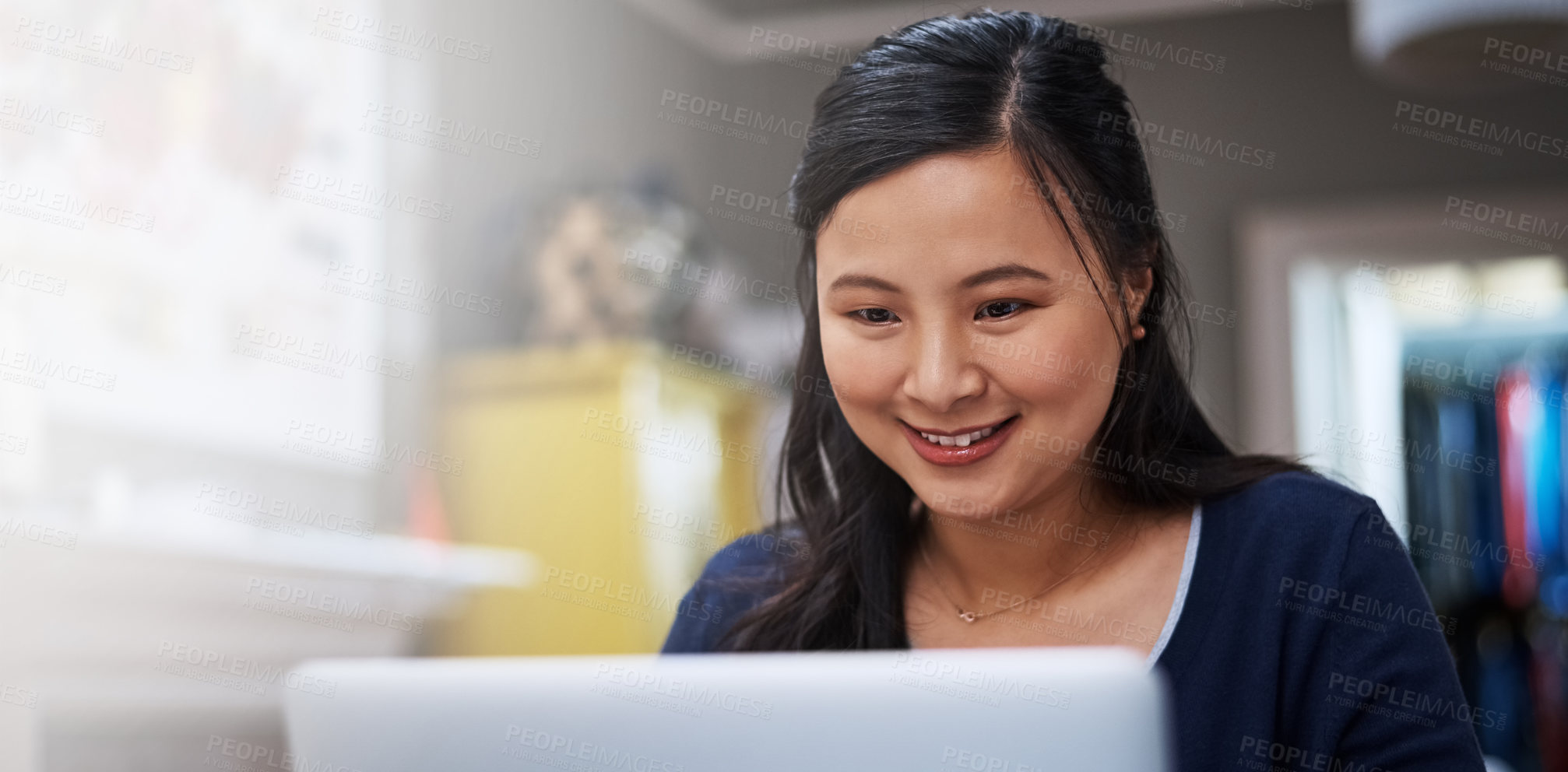 Buy stock photo Cropped shot of an attractive young female entrepreneur working on her laptop at home