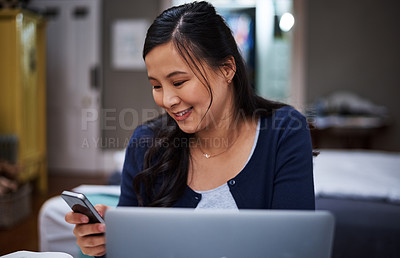 Buy stock photo Cropped shot of an attractive young female entrepreneur sending a text while working from home
