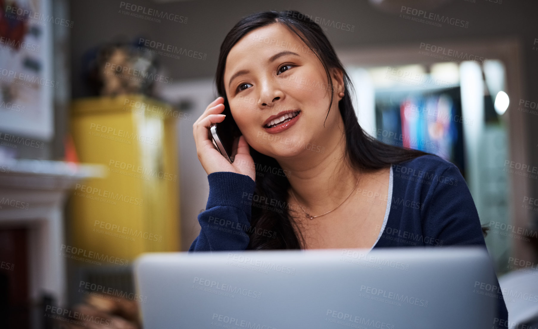 Buy stock photo Cropped shot of an attractive young female entrepreneur making a call while working from home