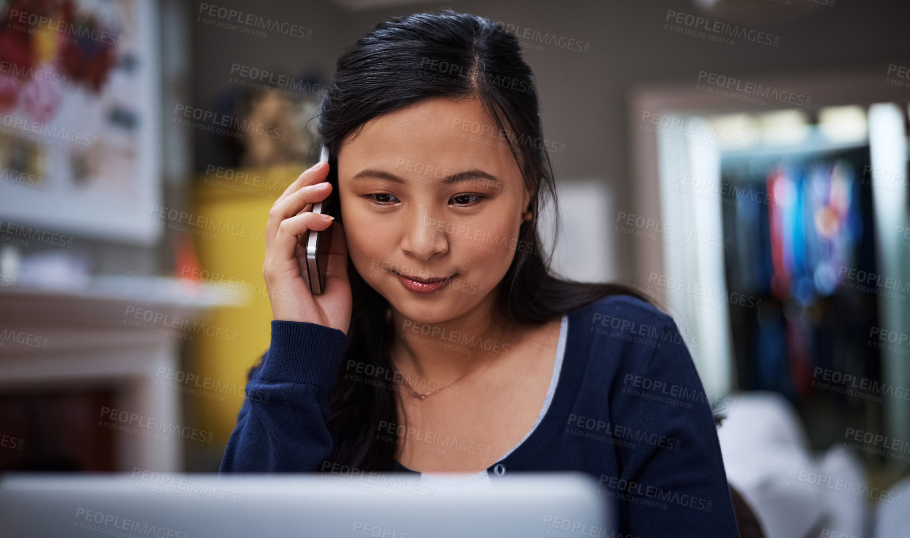 Buy stock photo Cropped shot of an attractive young female entrepreneur making a call while working from home