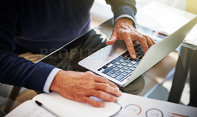 Buy stock photo Cropped shot of a businessman using a laptop at his work desk