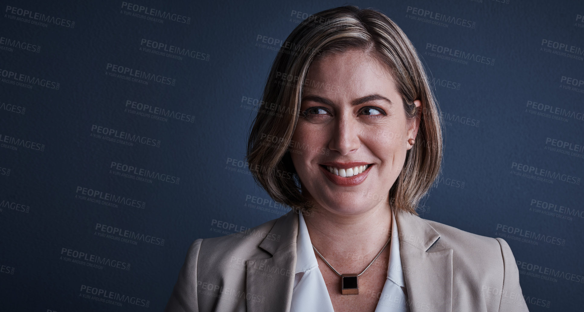 Buy stock photo Studio shot of an attractive young corporate businesswoman posing against a dark background