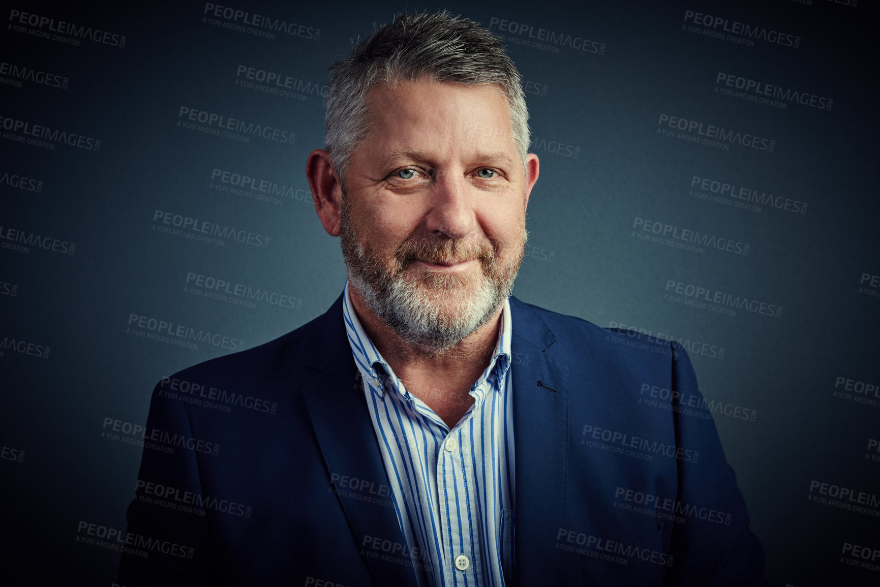 Buy stock photo Studio portrait of a mature businessman posing against a dark background