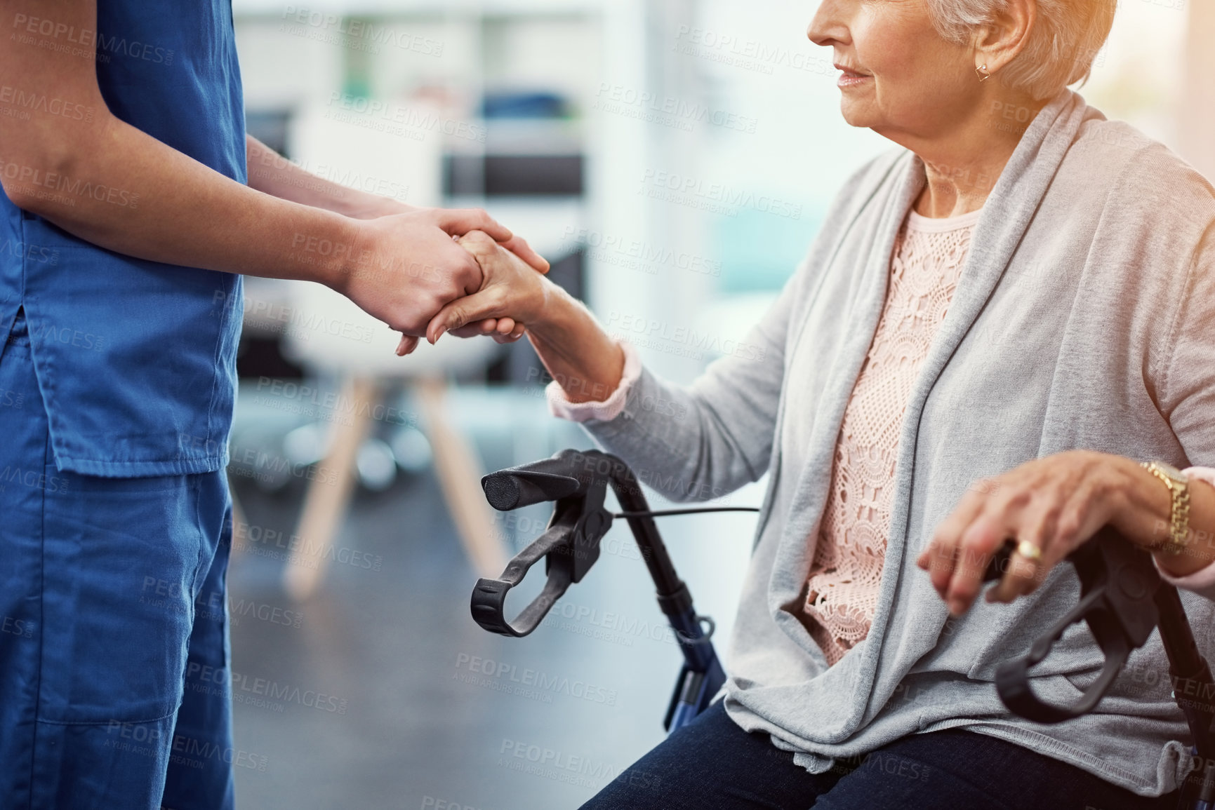 Buy stock photo Cropped shot of an unrecognizable female nurse holding her senior patient's hand in comfort