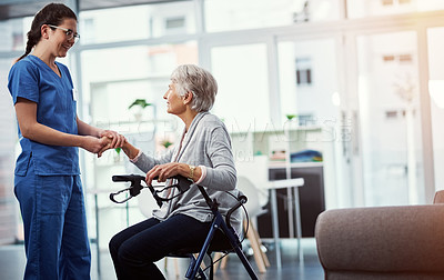 Buy stock photo Cropped shot of a young female nurse talking to her senior patient in the old age home