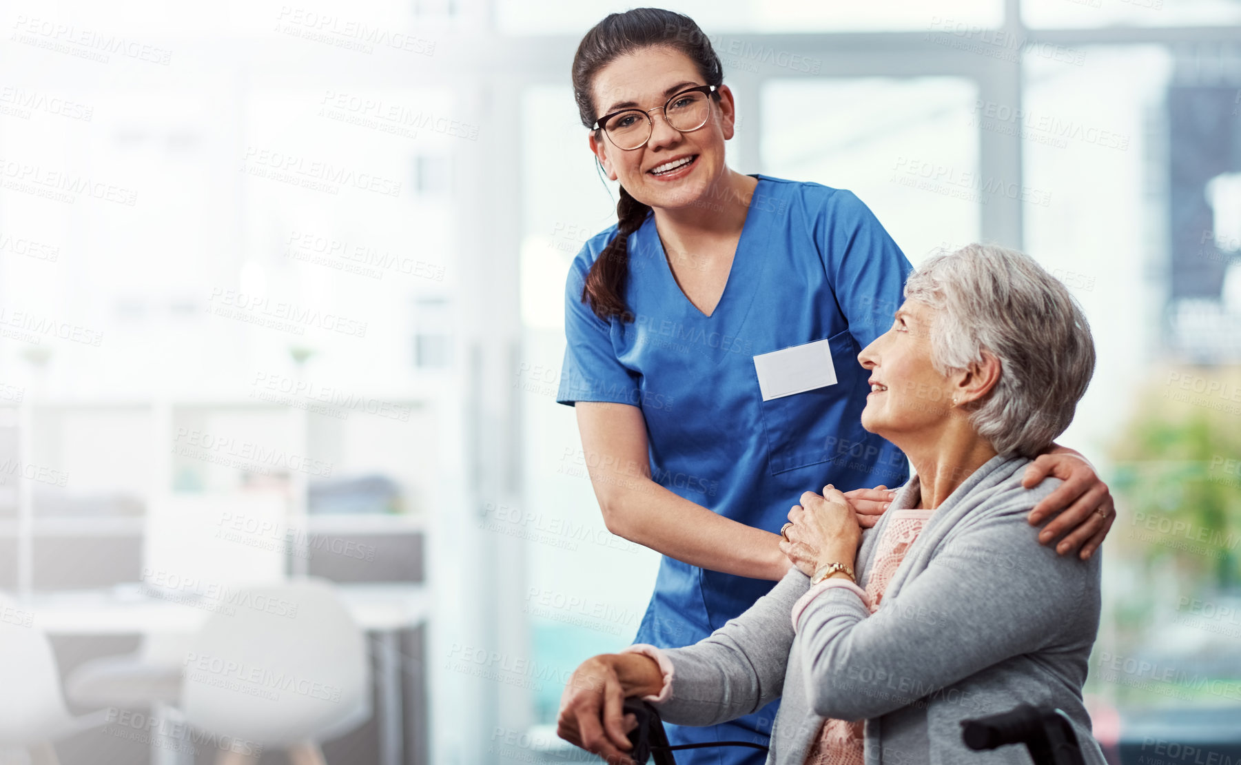 Buy stock photo Cropped shot of a young female nurse and her senior patient in the old age home