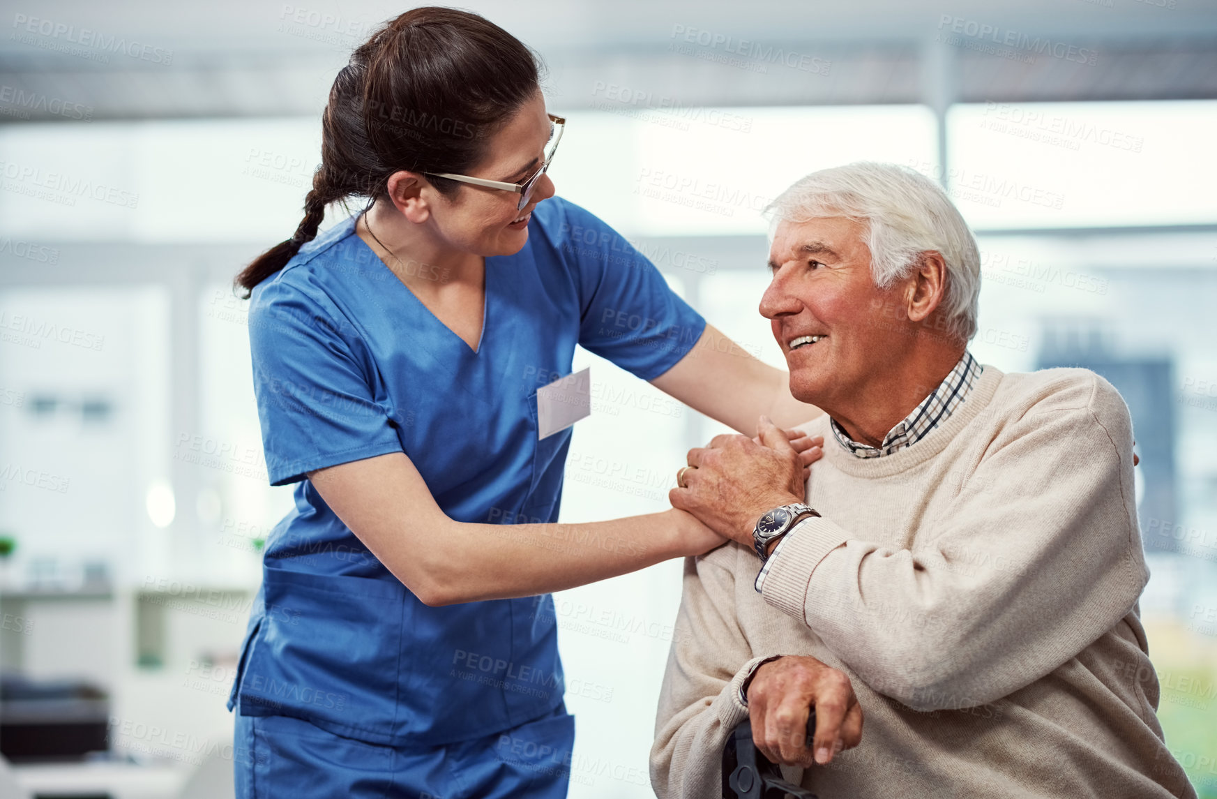 Buy stock photo Holding hands, happy and senior man with caregiver for empathy, support and compassion in facility. Nursing home, healthcare and nurse with elderly patient for assisted living, conversation or help