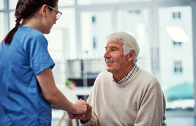 Buy stock photo Cropped shot of a young female nurse talking to her senior patient in the old age home