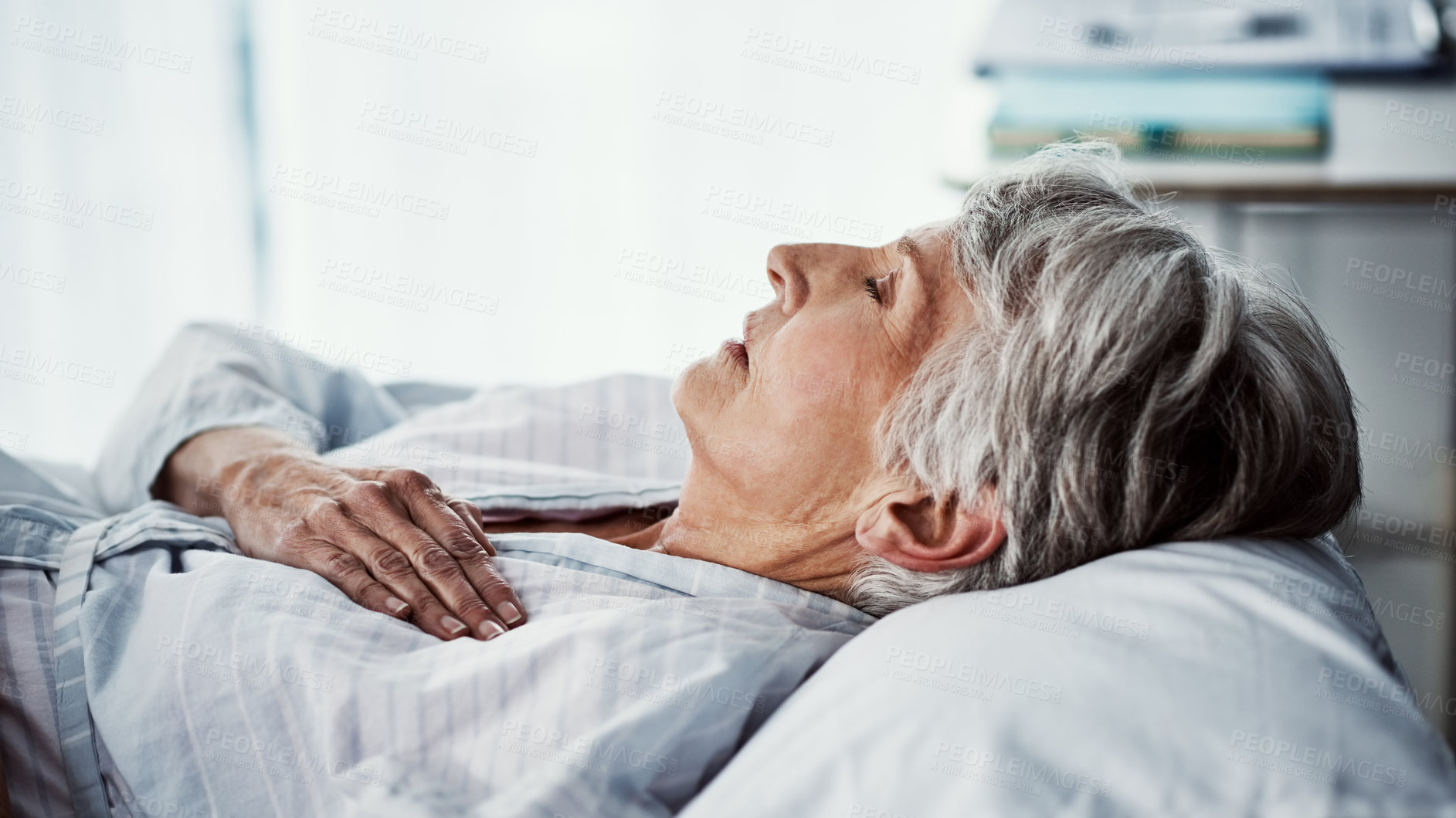 Buy stock photo Cropped shot of a sickly senior woman lying in a hospital bed