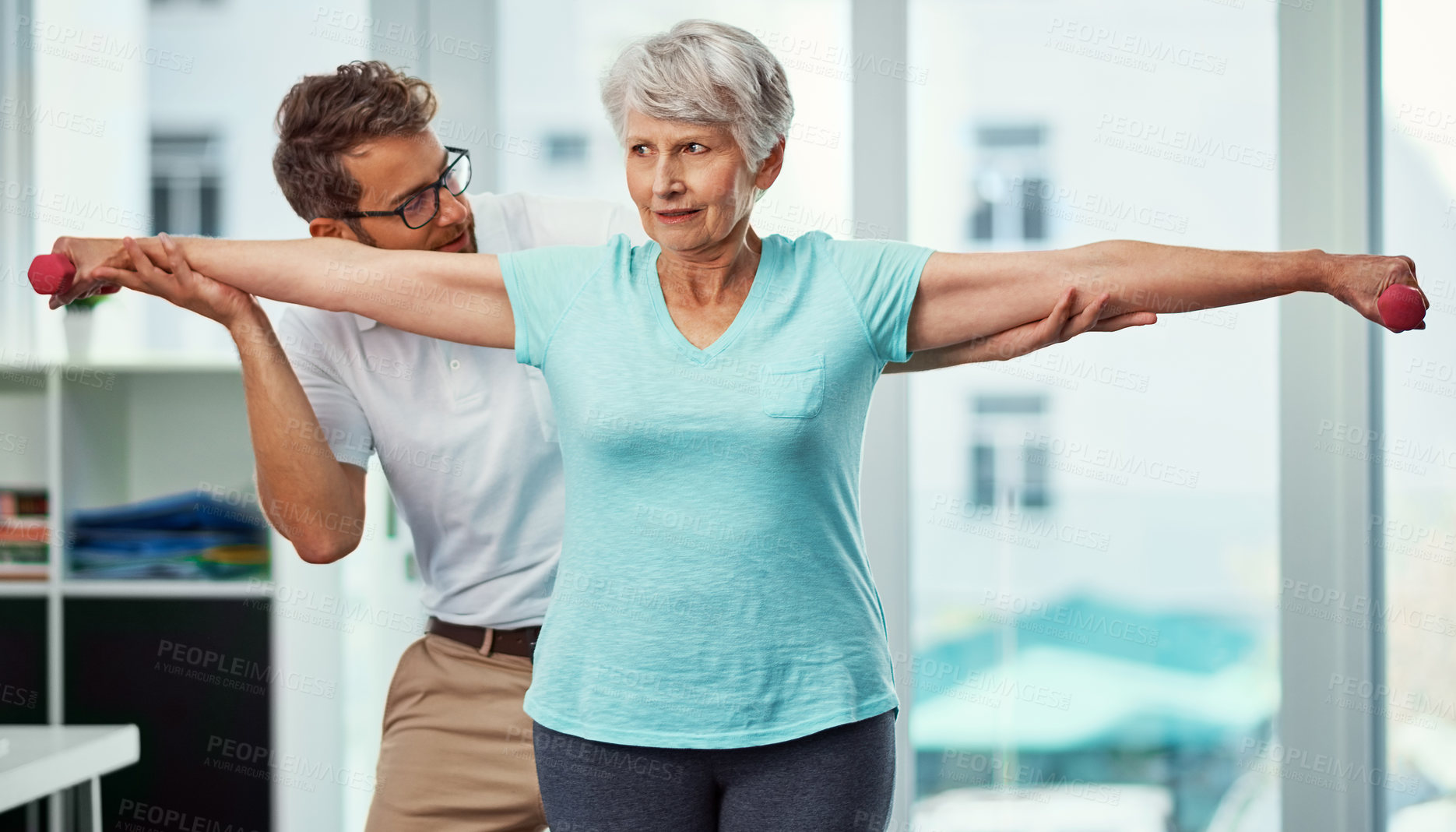 Buy stock photo Cropped shot of a senior woman working through her recovery with a male physiotherapist