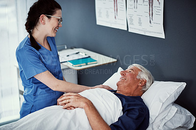 Buy stock photo High angle shot of a female carer assisting her male patient in a nursing home