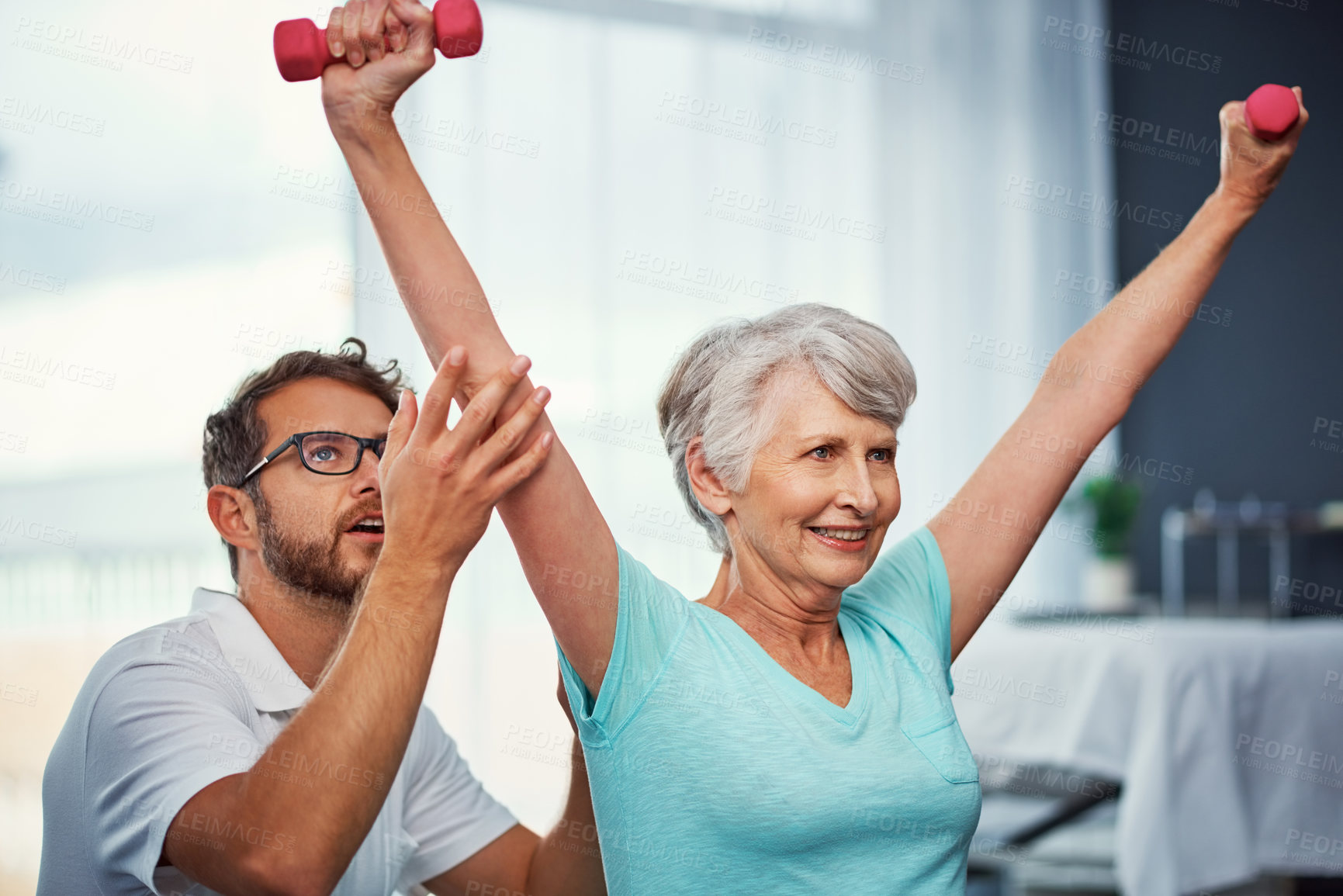 Buy stock photo Cropped shot of a senior woman working through her recovery with a male physiotherapist