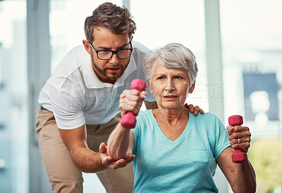 Buy stock photo Cropped shot of a senior woman working through her recovery with a male physiotherapist