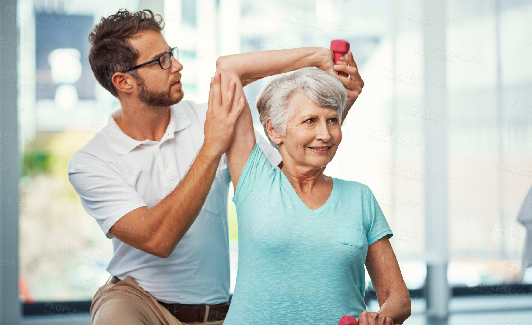 Buy stock photo Cropped shot of a senior woman working through her recovery with a male physiotherapist