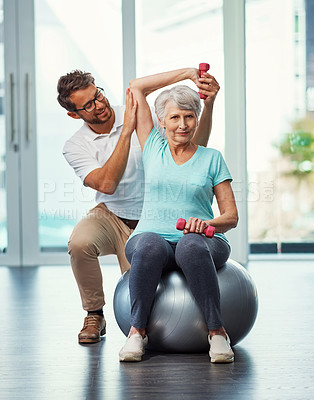 Buy stock photo Full length portrait of a senior woman working through her recovery with a male physiotherapist