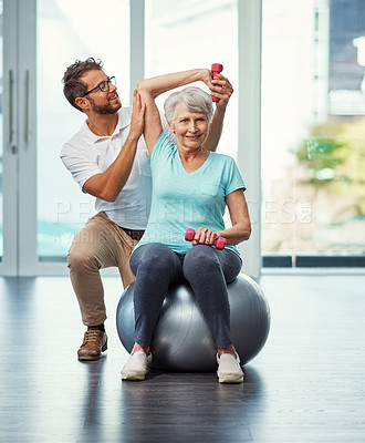 Buy stock photo Full length portrait of a senior woman working through her recovery with a male physiotherapist