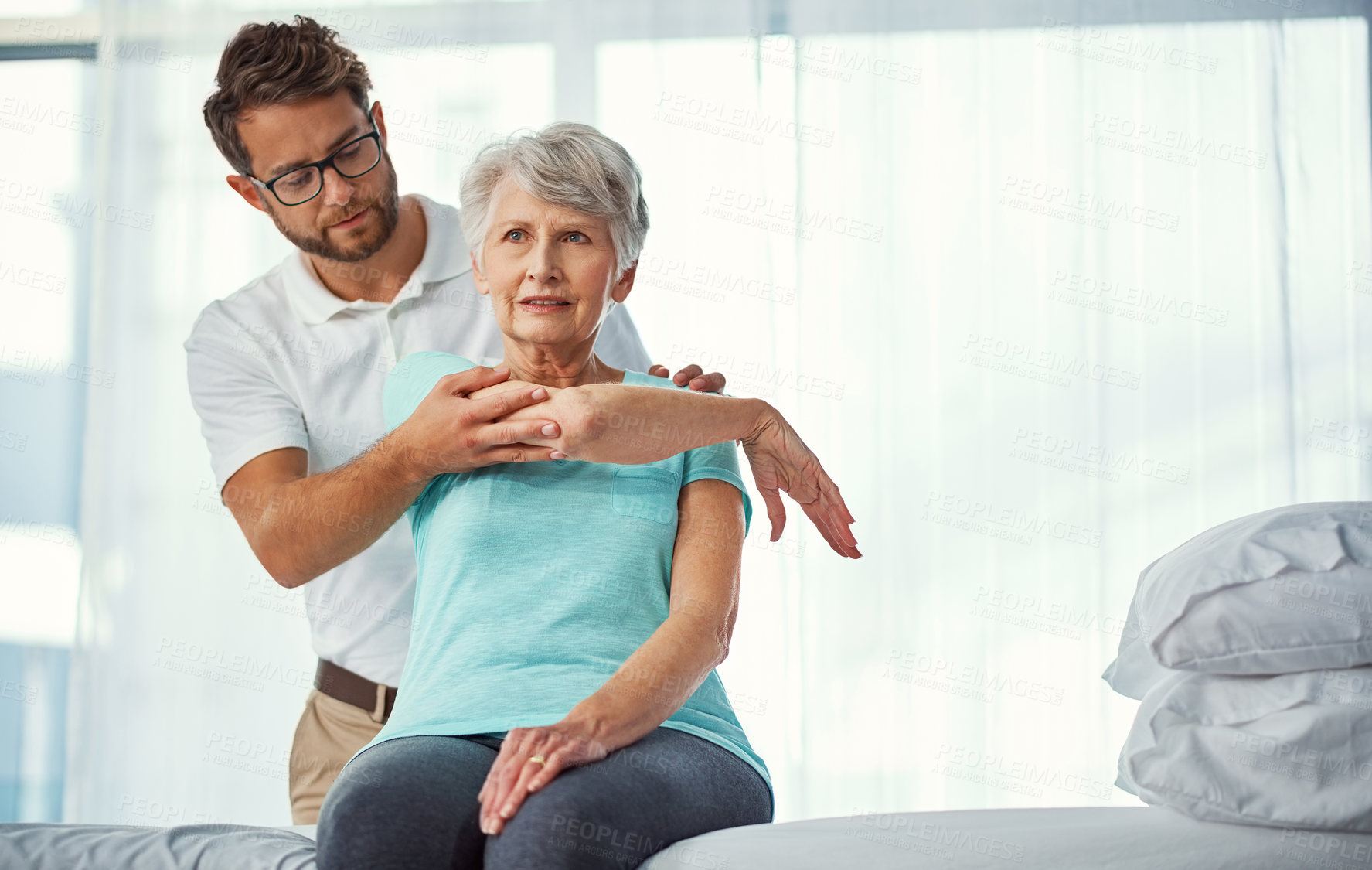 Buy stock photo Cropped shot of a senior woman working through her recovery with a male physiotherapist