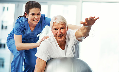 Buy stock photo Physiotherapist, senior man and stretching with ball, mobility and support for rehabilitation in clinic. Portrait, elderly person and healthcare worker with physical therapy, equipment and recovery.