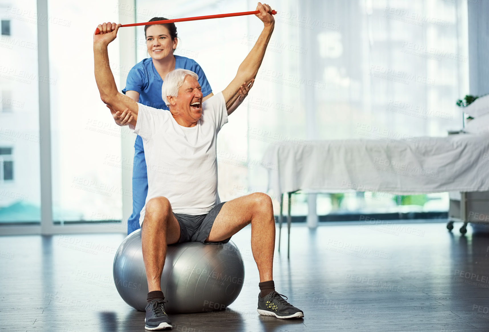 Buy stock photo Resistance band, senior man or laugh with physical therapist on ball for healthcare, fitness or help. Stretching, old patient and physiotherapy nurse for rehabilitation, exercise and funny in clinic