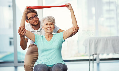Buy stock photo Cropped portrait of a senior woman working through her recovery with a male physiotherapist