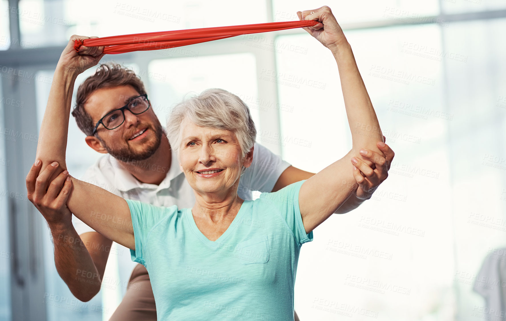 Buy stock photo Cropped shot of a senior woman working through her recovery with a male physiotherapist