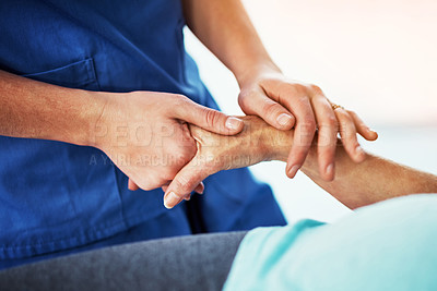 Buy stock photo Cropped shot of an unrecognizable female carer assisting her senior patient in the hospital