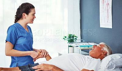 Buy stock photo Cropped shot of a young female nurse working through recovery with a senior patient
