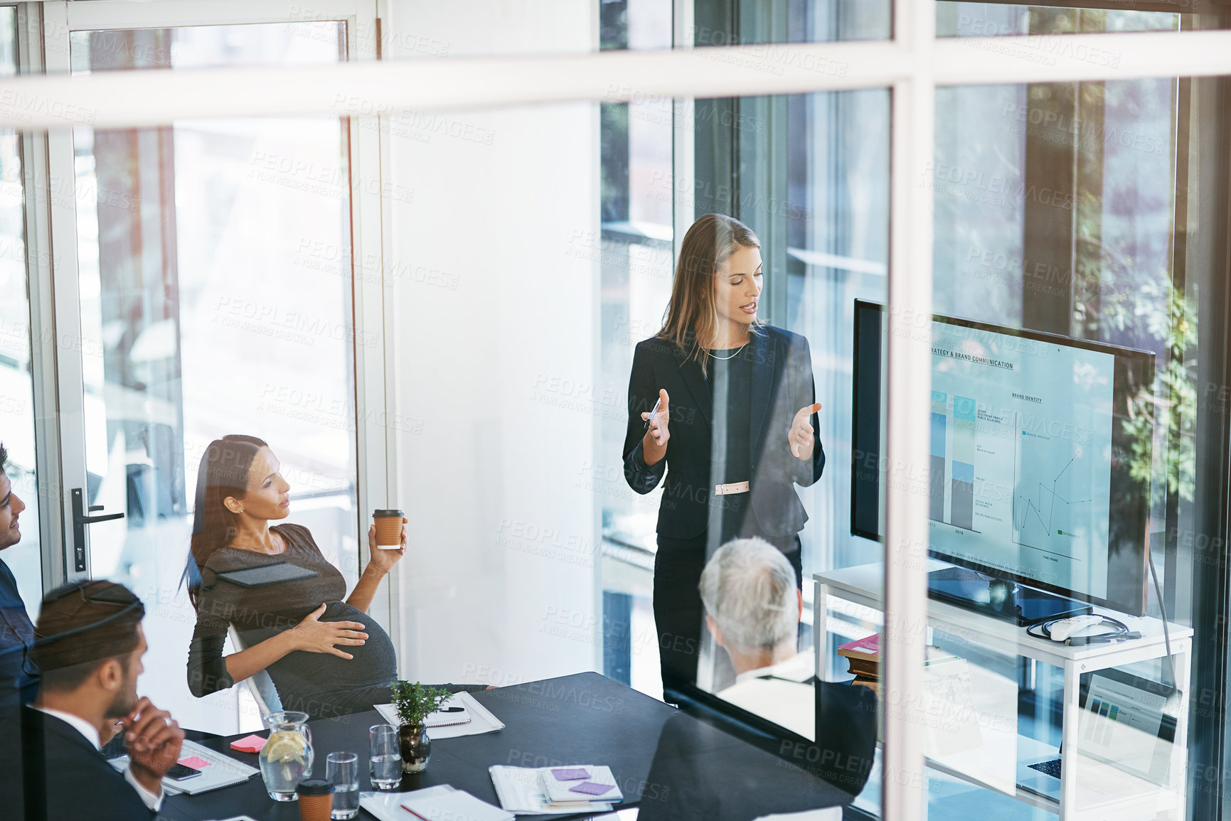 Buy stock photo High angle shot of a young businesswoman giving a presentation in the boardroom