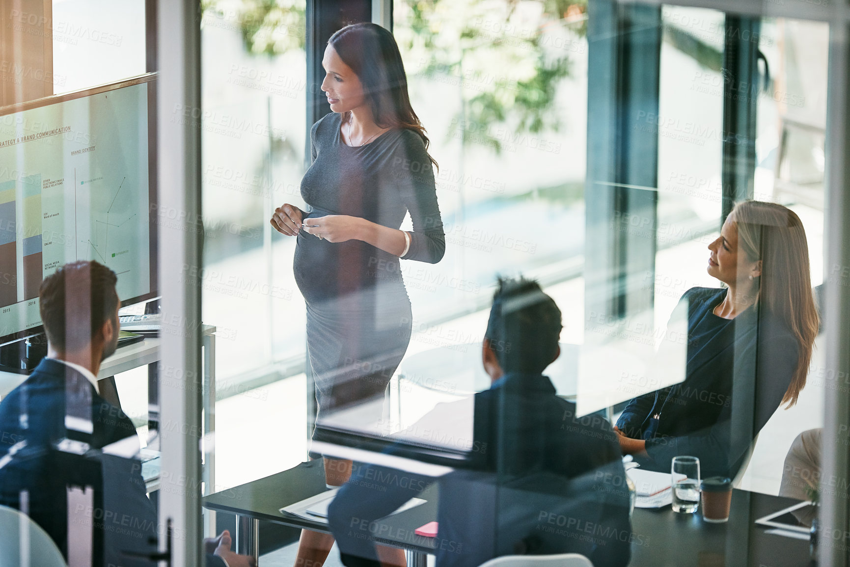 Buy stock photo High angle shot of a pregnant businesswoman giving a presentation in the boardroom