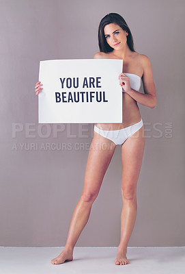 Buy stock photo Body positivity, sign and portrait of woman in studio with empowerment, beauty or motivation poster. Self love, happy and female person with board for inspiration or confidence by gray background.