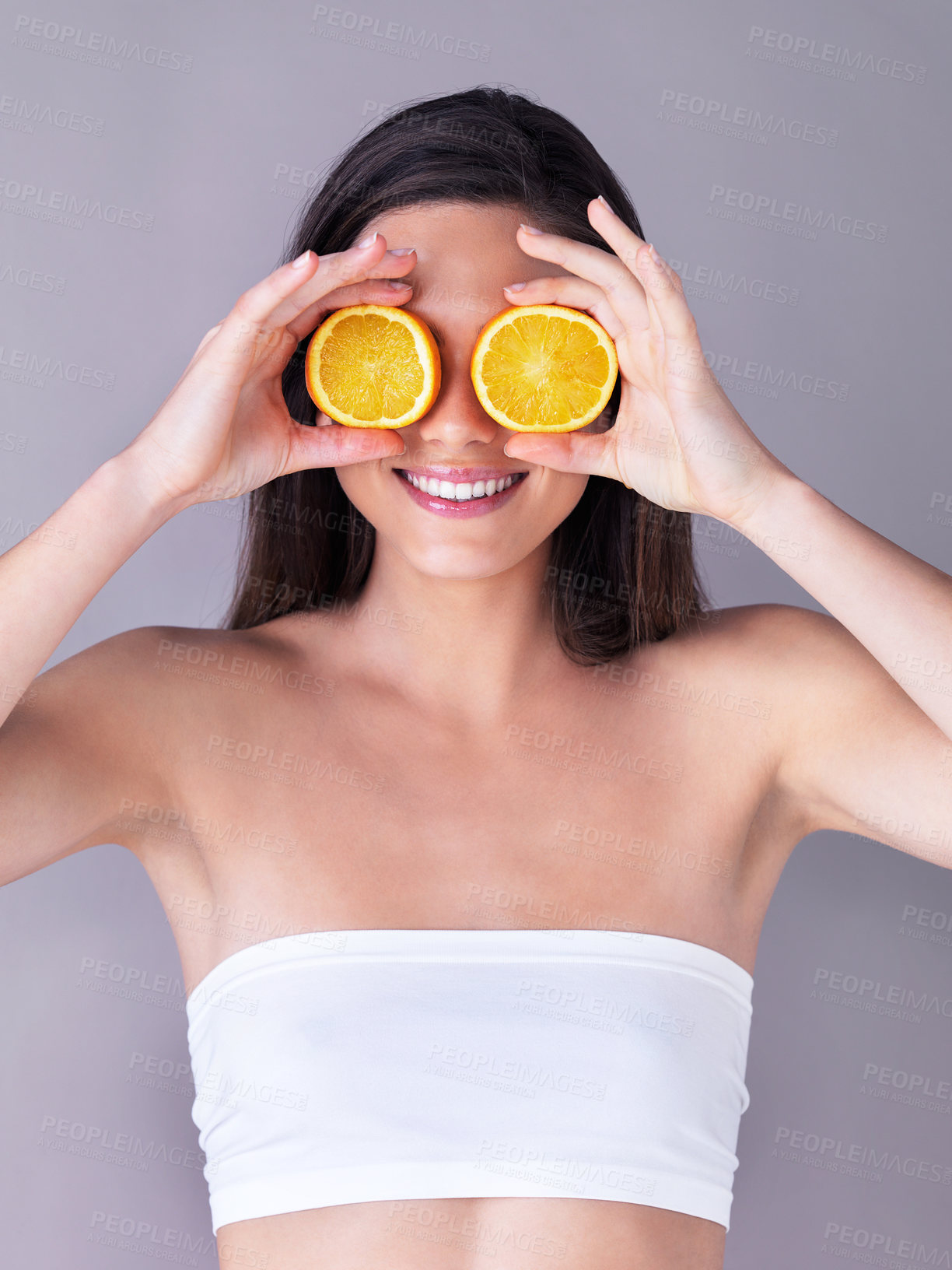 Buy stock photo Orange, skincare and woman in studio with organic, natural and vitamin c routine for glow. Health, smile and person with citrus fruit for dermatology treatment for face brightening by gray background